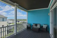 105 Winston Avenue Unit A, Atlantic Beach, NC 28512 — 2-bedroom condo in Triple Ess Shores, Atlantic Beach, NC, photo 15 of 37: Back Porch off Primary Bedroom