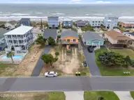210 W Beach Drive, Oak Island, NC 28465 — 4-bedroom waterfront home, Oak Island, NC, photo 3 of 42: 3-web-or-mls-DJI_20250614135850_0268_D