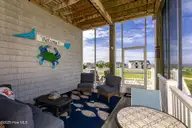 516 Blue Heron Drive, Newport, NC 28570 — 3-bedroom waterfront home in Blue Heron Bay, Newport, NC, photo 19 of 62: Screened porch off of living room