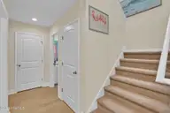 129 NE 13th Street, Oak Island, NC 28465 — 3-bedroom home, Oak Island, NC, photo 19 of 68: Downstairs Hallway