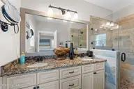 1404 W Yacht Drive, Oak Island, NC 28465 — 3-bedroom waterfront home in Pinners Point, Oak Island, NC, photo 13 of 46: Primary en-suite