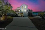 503 W Yacht Drive, Oak Island, NC 28465 — 4-bedroom home in Tranquil Harbor, Oak Island, NC, photo 5 of 53: Twilight with driveway