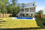 111 SW 22nd Street, Oak Island, NC 28465 — 4-bedroom home in Pinners Point, Oak Island, NC, photo 2 of 73: back and pool
