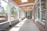 60 Oak Meadow Road, Pinehurst, NC 28374 — 4-bedroom home in Fairwoods on 7, Pinehurst, NC, photo 19 of 67: ScreenedPorch2
