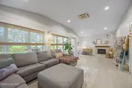 111 Mimosa Boulevard, Pine Knoll Shores, NC 28512 — 3-bedroom waterfront home in Pine Knoll Association, Pine Knoll Shores, NC, photo 19 of 54: Living Room/Sun Room