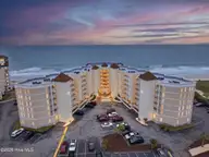 2000 New River Inlet Road 1201, North Topsail Beach, NC 28460 — 1-bedroom waterfront condo in St. Regis, North Topsail Beach, NC, photo 1 of 34: 2000NewRiverInletRoadUnit1201-1_Dusk_01