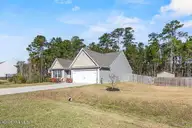 238 Poppleton Drive, Hampstead, NC 28443 — 3-bedroom home in Harrison Cove, Hampstead, NC, photo 2 of 43: m_2_front exterior