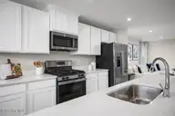 6007 Roundwood Drive NW, Ash, NC 28420 — 3-bedroom home in Sterling Oaks, Ash, NC, photo 11 of 15: Rosewood Kit Island