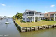 402 Dolphin Street, Sunset Beach, NC 28468 — 3-bedroom waterfront home, Sunset Beach, NC, photo 1 of 53: Canal Front Home on End Lot