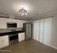 1320 Thomas Langston Road 2, Winterville, NC 28590 — 2-bedroom townhome in Legends, Winterville, NC, photo 5 of 10: Kitchen sliding door