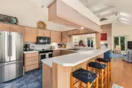 579 Coral Ridge Road, Pine Knoll Shores, NC 28512 — 4-bedroom waterfront home in Beacon's Reach, Pine Knoll Shores, NC, photo 14 of 62: Kitchen w/ Breakfast Bar