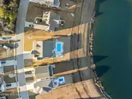 411 Summerhouse Drive, Holly Ridge, NC 28445 — 4-bedroom waterfront home in Summerhouse On Everett Bay, Holly Ridge, NC, photo 18 of 73: DJI_20260216165002_0717_D