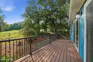 25 Turtle Point Road 1, Pinehurst, NC 28374 — 3-bedroom home in Unit 1, Pinehurst, NC, photo 11 of 63: Balcony off Living Room and Sunroom