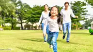 241 Maddox Drive, Aberdeen, NC 28315 — 3-bedroom townhome in Martin Farms, Aberdeen, NC, photo 14 of 25: Happy-Asian-Couple-Chasing-Young-Daughte