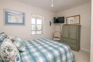 1131 S Shore Drive, Surf City, NC 28445 — 4-bedroom waterfront home in Horse Hammock, Surf City, NC, photo 13 of 40: Poolside South Queen Bedroom II