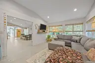 111 Mimosa Boulevard, Pine Knoll Shores, NC 28512 — 3-bedroom waterfront home in Pine Knoll Association, Pine Knoll Shores, NC, photo 18 of 54: Living Room/Sun Room