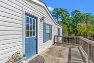 2807 Cross Bones Road SW, Supply, NC 28462 — 3-bedroom waterfront manufactured home in Buccaneer Hills, Supply, NC, photo 21 of 31: Front Porch with Pond View