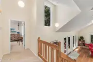 579 Coral Ridge Road, Pine Knoll Shores, NC 28512 — 4-bedroom waterfront home in Beacon's Reach, Pine Knoll Shores, NC, photo 24 of 62: Upstairs Hallway & Staircase