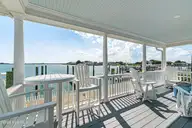 122 Front Street & Slip, Beaufort, NC 28516 — 4-bedroom waterfront home, Beaufort, NC, photo 4 of 63: Covered porch overlooking Taylors Creek