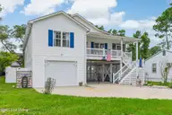 1803 W Yacht Drive, Oak Island, NC 28465 — 3-bedroom home in Pinners Point, Oak Island, NC, photo 3 of 39: Front side elevaiton
