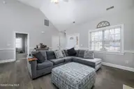 105 Fernie Lane, New Bern, NC 28560 — 3-bedroom home in The Lakes at Antioch, New Bern, NC, photo 11 of 48: Living Room with Vaulted Ceiling