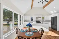 501 Shoreline Drive E, Sunset Beach, NC 28468 — 3-bedroom waterfront home in Shoreline Woods, Sunset Beach, NC, photo 6 of 39: Bright kitchen with wall of windows