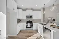 9579 Lily Pond Court NE, Leland, NC 28451 — 3-bedroom home in Lily Pond, Leland, NC, photo 14 of 33: Bar open to living room
