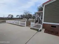 1984 River Street SW, Supply, NC 28462 — 3-bedroom manufactured home in Fishermans Village, Supply, NC, photo 4 of 37: Walkway to front porch