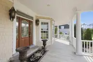 359 Bay Run, Newport, NC 28570 — 4-bedroom waterfront home in Bluewater Banks, Newport, NC, photo 7 of 74: Wrap around front porch