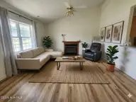 243 Parnell Road, Hubert, NC 28539 — 3-bedroom home in Foxtrace, Hubert, NC, photo 5 of 26: Living Room AI Staged