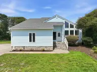 109 Oakleaf Drive, Pine Knoll Shores, NC 28512 — 3-bedroom waterfront home in Fairway Villas, Pine Knoll Shores, NC, photo 1 of 66: Front