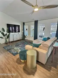 117 Halls Creek Drive, Swansboro, NC 28584 — 4-bedroom waterfront home in Halls Creek At The Hammocks, Swansboro, NC, photo 16 of 38: side angle living room