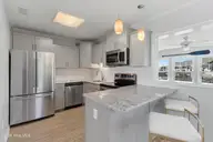 213 W Bogue Sound Drive, Atlantic Beach, NC 28512 — 3-bedroom waterfront home in Sound View Isles, Atlantic Beach, NC, photo 8 of 50: Kitchen with bar seating
