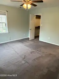 102 Dockside Drive, Jacksonville, NC 28546 — 4-bedroom waterfront home in Hunters Creek, Jacksonville, NC, photo 18 of 33: master bed toward walk-in closet