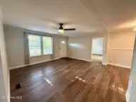 407 Maple Street SW, Shallotte, NC 28470 — 2-bedroom manufactured home in Lakewood Estates, Shallotte, NC, photo 8 of 26: living room from secondary bedrooms