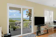 6611 Marsh Cove Road, Emerald Isle, NC 28594 — 3-bedroom waterfront home in Marsh Cove, Emerald Isle, NC, photo 6 of 52: Living room with sound views