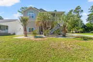 5801 E Yacht Drive, Oak Island, NC 28465 — 4-bedroom home in Tranquil Harbour Island, Oak Island, NC, photo 1 of 50