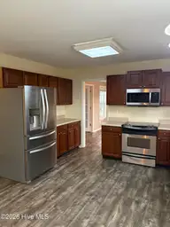 102 Dockside Drive, Jacksonville, NC 28546 — 4-bedroom waterfront home in Hunters Creek, Jacksonville, NC, photo 4 of 33: Kitchen toward dining room