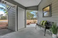724 Azalea Drive 433, Hampstead, NC 28443 — 2-bedroom waterfront condo in Plantation Pointe, Hampstead, NC, photo 7 of 43: Covered Porch & Storage