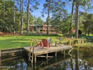 22 Pine Lake Drive, Whispering Pines, NC 28327 — 3-bedroom waterfront home in Pine Lakes, Whispering Pines, NC, photo 6 of 53: Private Dock and Paddleboat
