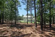 39 Forest Lake Drive, Jackson Springs, NC 27281 — 4-bedroom home in Foxfire Village East, Jackson Springs, NC, photo 5 of 49: 5 Back of home from property line