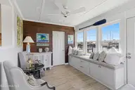 213 W Bogue Sound Drive, Atlantic Beach, NC 28512 — 3-bedroom waterfront home in Sound View Isles, Atlantic Beach, NC, photo 14 of 50: Sun room with sound views