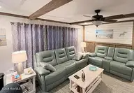 600 Ocean Spray Drive, Cedar Point, NC 28584 — 3-bedroom manufactured home in Ocean Spray, Cedar Point, NC, photo 4 of 14: Den view from Kitchen