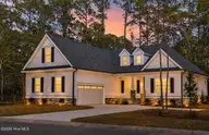 992 Ashburton Road SE, Bolivia, NC 28422 — 3-bedroom waterfront home in Riversea  Plantation, Bolivia, NC, photo 1 of 64: Front view at sunset