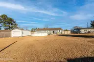 319 Riggs Road, Hubert, NC 28539 — 3-bedroom home in Huntington Marsh, Hubert, NC, photo 6 of 68: Back yard with 12x24 shed and pool