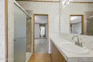 124 Zack Circle, Elizabeth City, NC 27909 — 3-bedroom manufactured home in Red Oak, Elizabeth City, NC, photo 19 of 36: Primary Ensuite Bathroom