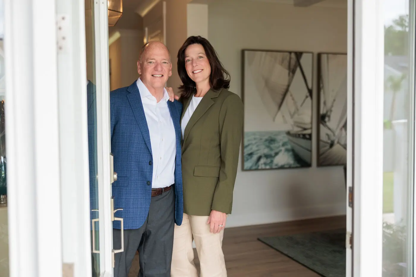 Buddy and Erin Blake, Wilmington NC real estate, welcoming you at an open front door
