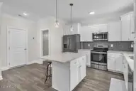 7177 Old Stump Drive SE, Leland, NC 28451 — 4-bedroom home in Cypress Bay, Leland, NC, photo 16 of 70: Kitchen Island