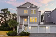 52 Pier View Court, Hampstead, NC 28443 — 4-bedroom waterfront home, Hampstead, NC, photo 2 of 60: 1_front center exterior sunsey