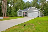 1109 Coral Reef Drive, New Bern, NC 28560 — 4-bedroom home in Fairfield Harbour, New Bern, NC, photo 3 of 37: Brown - side view